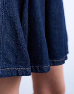 Model wearing Denim pleated wrap mini skirt in indigo