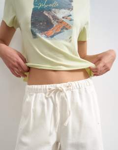 Model wearing Denim pull on barrel short in bone