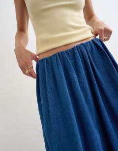 Model wearing Denim pull on circle skirt in mid blue