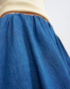 Model wearing Denim pull on circle skirt in mid blue