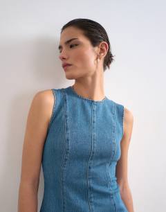 Model wearing Denim seamed flippy mini dress in mid blue