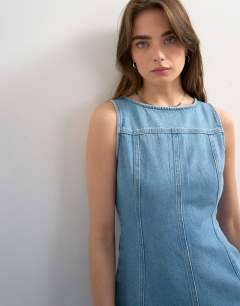 Model wearing Denim seamed mini dress in bleach