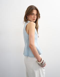 Model wearing Denim seamed peplum top in bleach