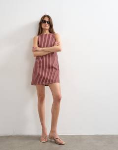 Model wearing Denim shift mini dress red and pink stripe