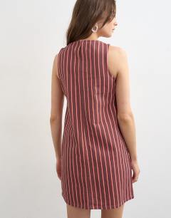 Model wearing Denim shift mini dress red and pink stripe