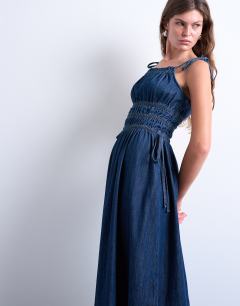 Model wearing Denim shirred maxi dress with straps in mid blue