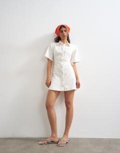 Model wearing Denim shirt dress with back cut out in white