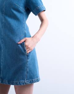 Model wearing Denim short sleeved structured mini dress in mid blue