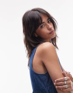 Model wearing Denim slash neck flippy mini dress in mid blue