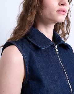Model wearing Denim sleeveless zip through dress in indigo rinse