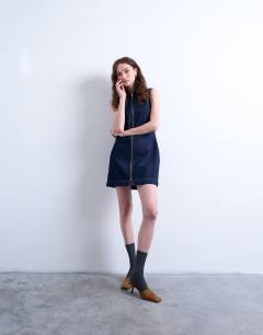 Model wearing Denim sleeveless zip through dress in indigo rinse