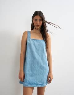 Model wearing Denim square neck pinny dress in bleach