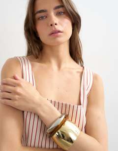 Model wearing Denim square neck pinny dress in ecru and red stripe