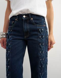 Model wearing Denim straight leg jean with extreme lace-up in deep blue