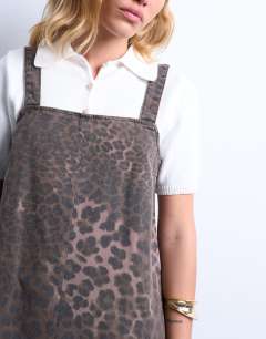 Model wearing Denim tailored pinafore dress in leopard print
