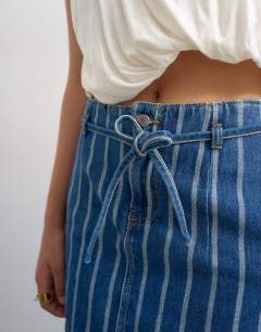 Model wearing Denim tie dart pelmet mini skirt in blue stripe