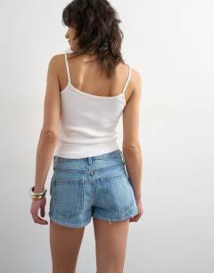 Model wearing Denim ultra mini short in mid blue