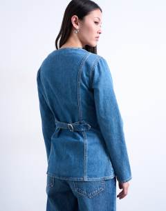 Model wearing Denim v neck cinched in shirt in mid blue