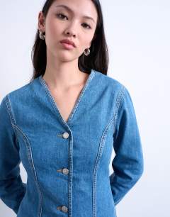 Model wearing Denim v neck cinched in shirt in mid blue