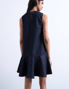 Model wearing Denim v neck peplum mini dress in indigo rinse