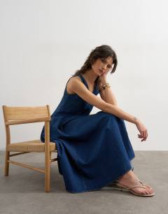 Model wearing Denim v neck seamed full maxi dress in rich blue