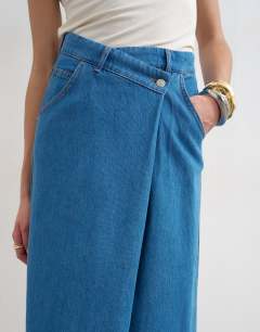 Model wearing Denim wrap circle midi skirt in mid blue