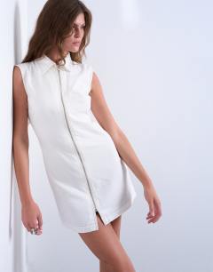 Model wearing Denim zip through collar sleeveless mini dress in white
