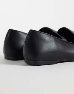 Model wearing Denise slip on flat shoe in black
