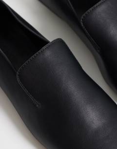 Model wearing Denise slip on flat shoe in black