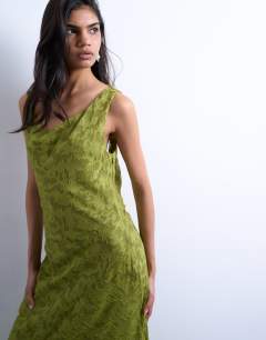 Model wearing Devore occasion twist shoulder midi dress in green