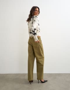Model wearing Dilan baggy low rise jean in khaki green