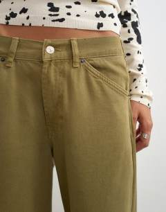 Model wearing Dilan baggy low rise jean in khaki green