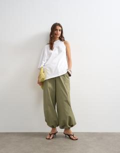 Model wearing Distorted cape top in ecru