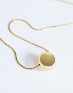Model wearing Dolly waterproof necklace with ball in stainless gold