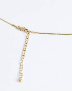 Model wearing Dolly waterproof necklace with ball in stainless gold