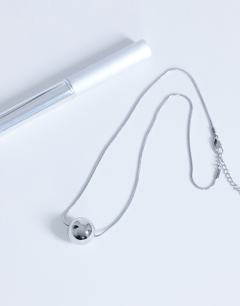 Model wearing Dolly waterproof necklace with ball in stainless silver