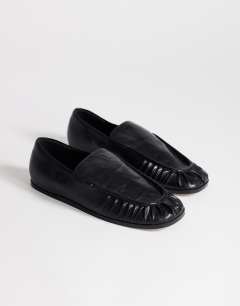 Model wearing Dora ruched loafer in black