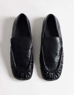 Model wearing Dora ruched loafer in black