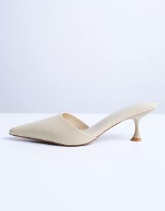 Model wearing Dorota kitten heel pointed mule in cream