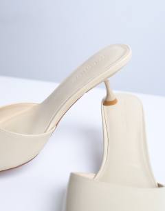Model wearing Dorota kitten heel pointed mule in cream