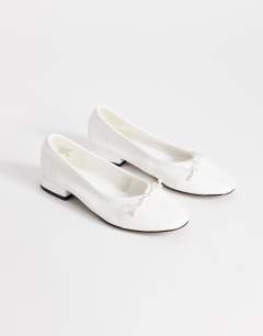 Model wearing Dottie block heel ballet shoe in white