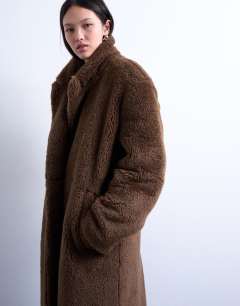 Model wearing Double breasted borg longline coat in brown
