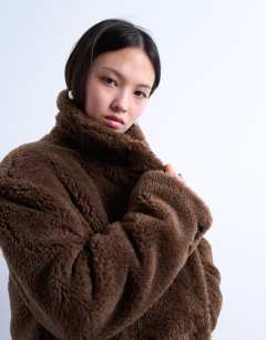 Model wearing Double breasted borg longline coat in brown