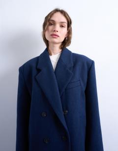 Model wearing Double breasted mensy overcoat with wool in navy