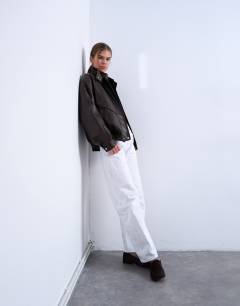 Model wearing Double fronted seam detail bomber in brown