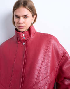 Model wearing Double fronted seam detail bomber in red