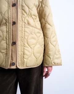 Model wearing Double layer fronted liner jacket in sand