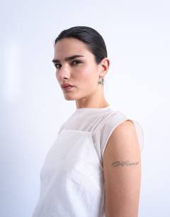 Model wearing Double layer sleeveless tunic top in ivory