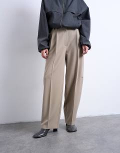 Model wearing Double pleated slouchy trouser in taupe