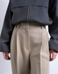 Model wearing Double pleated slouchy trouser in taupe